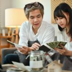 Young couple planning retirement finances or household expenses in living room