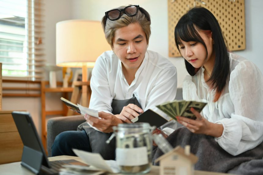 Young couple planning retirement finances or household expenses in living room